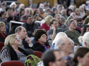 People listen to speakers during a planning board meeting regarding Dragon Springs' planned expansion, Wednesday, April 10, 2019, in Port Jervis, N.Y. Expansion plans for the Falun Gong compound in the hills of upstate New York have heightened tensions with neighbors who worry that the religious group could harm the area's environment and rural character by bringing in more buildings, more residents and more visitors.