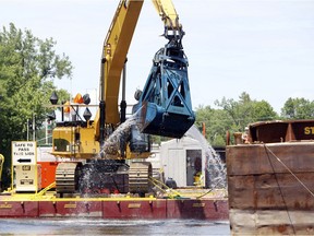 FILE - In this June 10, 2011 file photo, crews dredge the Hudson River in Fort Edward, N.Y. The work is part of a project on the upper-Hudson to clean up PCBs released by General Electric decades ago. The Environmental Protection Agency is poised to make an announcement Thursday, April 11, 2019, on GE's $1.7 billion Hudson River cleanup.