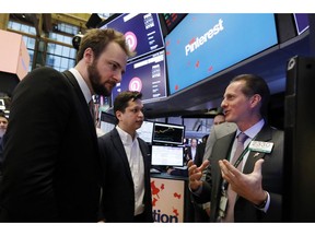 Pinterest co-founder & CEO Ben Silbermann, center, and fellow co-founder and chief product officer Evan Sharp, left, meet with specialist Glenn Carell on the New York Stock Exchange trading floor, Thursday, April 18, 2019, before the company's IPO.