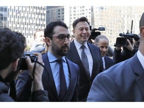 Tesla CEO Elon Musk, center, arrives at Manhattan Federal Court, in New York, Thursday, April 4, 2019. Musk and his lawyers were appearing before a federal judge in New York who will decide whether the Tesla CEO should be held in contempt of court for violating an agreement with the U.S. Securities and Exchange Commission.