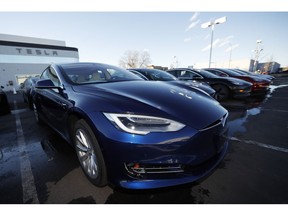 FILE - In this Sunday, Feb. 3, 2019, file photograph, an unsold 2019 S75D sits at a Tesla dealership in Littleton, Colo. Tesla's assembly lines slowed down during a rocky start to the new year, which will likely magnify nagging doubts about whether the electric car pioneer will be able to make the leap into mass market.