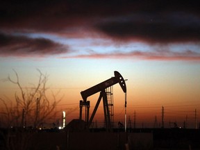 An oil pumpjack works at dawn in the Permian Basin oil field in Texas.