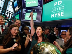 PagerDuty CEO Jennifer Tejada raises her gavel in celebration after ringing a ceremonial bell as her company's IPO begins trading, on the floor of the New York Stock Exchange, Thursday, April 11, 2019.
