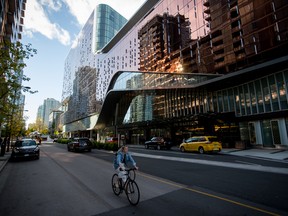 A cyclist rides past the Parq Vancouver hotel and casino in Vancouver.