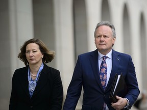 Stephen Poloz, Governor of the Bank of Canada and Senior Deputy Governor Carolyn Wilkins make their way to hold a press conference at the National Press Theatre in Ottawa on Wednesday.