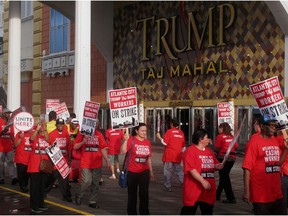 In this July 1, 2016, photo, members of Local 54 of the Unite Here casino workers union picket outside the Trump Taj Mahal casino in Atlantic City N.J. shortly after going on strike against the casino, which was owned by billionaire investor Carl Icahn. On Wednesday, April 10, 2019, the union called on casino regulators in New Jersey, Nevada and Ohio to protect casino workers from hedge fund or private equity firms that own casinos if they seek to quickly extract profits from the properties while hurting workers.