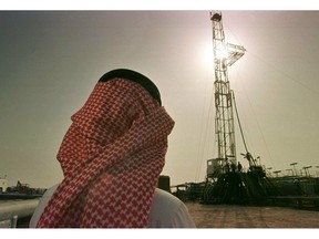 FILE - In this Feb. 26, 1997 file photo, Khaled al-Otaiby, an official of the Saudi oil company Aramco, watches progress at a rig at the al-Howta oil field near Howta, Saudi Arabia. According to an assessment published Monday, April 1, 2019, by Moody's Investors Services, the net profits of Saudi Aramco reached $111 billion last year. That places Aramco ahead of some of the world's most profitable firms. In their first-ever grade assessment for Aramco, Fitch Ratings issued the firm an A+ rating, while Moody's gave it it's A1 rating ahead of its upcoming bonds sale.