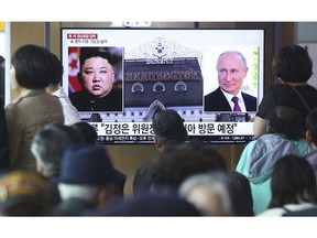 People watch a TV screen showing images of North Korean leader Kim Jong Un, left, and Russian President Vladimir Putin, right, during a news program at the Seoul Railway Station in Seoul, South Korea, Tuesday, April 23, 2019. North Korea confirmed Tuesday that Kim will soon visit Russia to meet with Putin in a summit that comes at a crucial moment for tenuous diplomacy meant to rid the North of its nuclear arsenal. The Korean letters on the screen read:: "Kim Jong Un plans to visit Russia ."