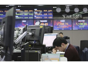 A currency trader rubs his eyes at the foreign exchange dealing room of the KEB Hana Bank headquarters in Seoul, South Korea, Friday, April 5, 2019. Shares are mixed in Asia, with Chinese markets closed for a holiday. Japan's benchmark Nikkei 225 rose early Friday while South Korea was flat and shares fell in Australia and New Zealand.