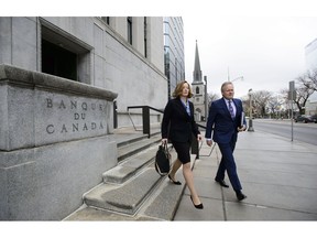 Stephen Poloz, Governor of the Bank of Canada and Senior Deputy Governor Carolyn Wilkins make their way to hold a press conference at the National Press Theatre, in Ottawa on Wednesday, April 24, 2019.