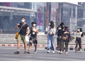 Tourists wear masks in Chiang Mai province, Thailand, Tuesday, April 2, 2019. The air hanging over Thailand's far north has become so polluted, the prime minister went Tuesday to see in person what's been called a severe health crisis.