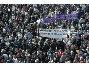 Protesters attend a demonstration against rent increase in Berlin, Germany, Saturday, April 6, 2019. Slogan in the foreground reads 'Living Is Not A Product - Stopp Rent Insanity'.