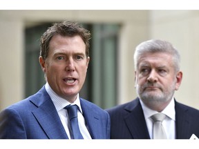 Australia's Attorney-General Christian Porter, left, and Minister for Communications Mitch Fifield hold a press conference at Parliament House, in Canberra, Wednesday, April 4, 2019. Australia's Parliament passed legislation that could imprison social media executives if their platforms stream violent images such as the New Zealand mosque shootings.