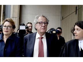 Australian actor Geoffrey Rush, centre, arrives at the Supreme Court in Sydney, Thursday, April 11, 2019. Oscar-winning actor Rush won his defamation case against a Sydney newspaper publisher and journalist over reports he had been accused of inappropriate behavior toward an actress.