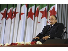FILE - In this April 28, 2014 file photo, Algerian President Abdelaziz Bouteflika sits on a wheelchair after taking oath as President, in Algiers. Embattled Algerian President Abdelaziz Bouteflika says he will step down before his fourth term ends on April 28. In a short statement issued on Monday April 1, 2019, the president's office said Bouteflika would take "important steps to ensure the continuity of the functioning of state institutions" during a transition period following his departure from the post he's held since 1999.