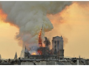 In this image made available on Tuesday April 16, 2019 flames and smoke rise from the blaze as the spire starts to topple on Notre Dame cathedral in Paris, Monday, April 15, 2019. An inferno that raged through Notre Dame Cathedral for more than 12 hours destroyed its spire and its roof but spared its twin medieval bell towers, and a frantic rescue effort saved the monument's "most precious treasures," including the Crown of Thorns purportedly worn by Jesus, officials said Tuesday.
