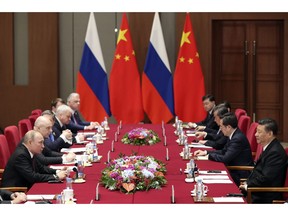 Russian President Vladimir Putin, left, and Chinese President Xi Jinping, right, attend the meeting at Friendship Palace in Beijing Friday, April 26, 2019.