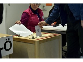 A man casts his vote in the parliamentary elections in Helsinki Finland on Sunday April 14, 2019. Finns are voting in a parliamentary election in which reforming the nation's generous welfare model and tackling climate change have emerged as key issues.