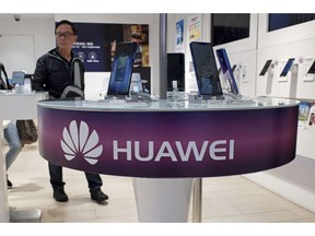 FILE - In this March 29, 2019, file photo, Huawei's mobile phones are displayed at a telecoms service shop in Hong Kong. Chinese tech giant Huawei said Monday, April 22, 2019, its revenue rose 39 percent over a year earlier in the latest quarter despite U.S. pressure on allies to shun its telecom and network technology as a security risk.