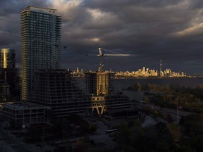 Condominiums are seen under construction in front of the skyline in Toronto.