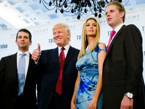 Donald Trump poses with his children Don Trump Jr., left, Ivanka and Eric at a ribbon cutting ceremony of the Trump International Hotel and Tower at Toronto in 2012.