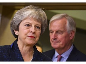 FILE - In this Nov. 24, 2018 file photo, British Prime Minister Theresa May, left, walks ahead of European Union chief Brexit negotiator Michel Barnier at EU headquarters in Brussels. EU chief negotiator Michel Barnier said on Tuesday, April 2, 2019 that a no-deal exit of Britain becomes day after day more likely after the UK parliament again rejected alternatives to the government's unpopular European Union divorce deal.