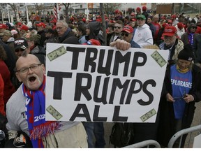 President Donald Trump supporter, Jammer Batzler. shows his support as he waits to get in to a rally to hear him speak Saturday, April 27, 2019, in Green Bay, Wis.