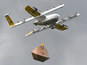 this Tuesday, Aug, 7, 2018, photo a Wing Hummingbird drone carries a package of ice cream and popsicles as it leaves its launch site during a delivery flight demonstration in Blacksburg, Virginia.