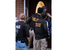 In this photo provided by the Department of Health and Human Services, Office of Inspector General, HHS Office of Inspector General agents, and other law enforcement officers, take part in arrests Tuesday, April 9, 2019, in Queens, N.Y., as they break up a billion-dollar Medicare scam that peddled unneeded orthopedic braces to hundreds of thousands of seniors nationwide, using a network of foreign call centers. (Department of Health and Human Services, Office of Inspector General via AP)