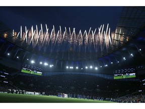Fireworks explode above the stadium as the teams stand on the pitch before the start of the English Premier League soccer match between Tottenham Hotspur and Crystal Palace, the first Premiership match at the new Tottenham Hotspur stadium in London, Wednesday, April 3, 2019.
