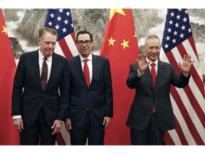 Chinese Vice Premier Liu He, right, gestures as U.S. Treasury Secretary Steven Mnuchin, center, chats with his Trade Representative Robert Lighthizer, left, before they proceed to their meeting at the Diaoyutai State Guesthouse in Beijing, Wednesday, May 1, 2019.