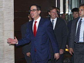 U.S. Treasury Secretary Steven Mnuchin gestures as he speaks to the media upon his arrival at a hotel in Beijing, Tuesday, April 30, 2019. Mnuchin arrived in China's capital to hold a new high-level trade talks with China on May 1.