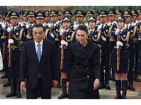 New Zealand Prime Minister Jacinda Ardern, right, walks with Chinese Premier Li Keqiang during a welcome ceremony at the Great Hall of the People in Beijing, Money, April 1, 2019.