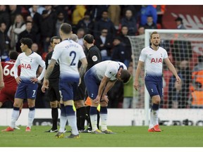 Tottenham players react at the end of the English Premier League soccer match between Liverpool and Tottenham Hotspur at Anfield stadium in Liverpool, England, Sunday, March 31, 2019.