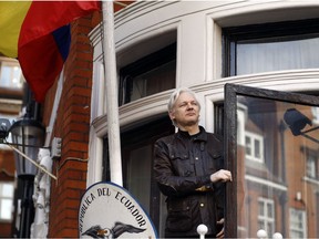 FILE- In this Friday May 19, 2017 file photo, WikiLeaks founder Julian Assange greets supporters outside the Ecuadorian embassy in London. Ecuador's President Lenin Moreno said on Tuesday, March 2, 2019, that he wants to reach an agreement for Assange to leave the Embassy in London as soon as possible, as long as his life is not in danger.
