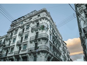 Algerian flags are displayed outside balconies, supporting the current protest movement that has forced out longtime President Abdelaziz Bouteflika, in downtown Algiers, Algeria, Monday, April 8, 2019. The pro-democracy movement has forced out Bouteflika and demanded that other top figures leave too.