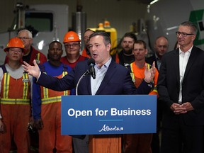 Alberta Premier Jason Kenney (middle) and Alberta Finance Minister Travis Toews (right) announced at Lafarge Infrastructure in Edmonton on Monday May 13, 2019 that their government plans to create jobs in the province by having the lowest corporate business tax rate in Canada.