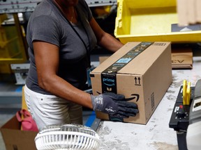 A worker packs an Amazon order at a fulfillment centre in Baltimore, Maryland.