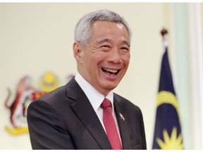 Singaporean Prime Minister Lee Hsien Loong smiles after a press conference with Malaysian Prime Minister Mahathir Mohamad in Putrajaya, Malaysia, Tuesday, April 9, 2019. Singapore reportedly has passed a law criminalizing the publication of fake news and allowing the government to block and order the removal of such content.