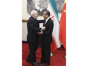 Chinese Foreign Minister Wang Yi, right, meets Iranian Foreign Minister Mohammad Javad Zarif at the Diaoyutai State Guesthouse in Beijing, Friday, May 18, 2019.