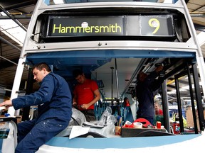 Employees work in the cabin of a bus at Paxton Ltd's assembly plant, part of the Alexander Dennis Ltd. group, in Scarborough, U.K.