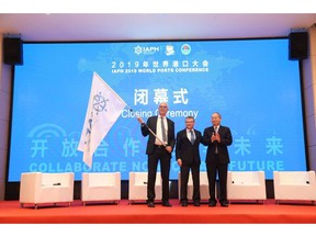 Mr. Chen Hongxian(1st from Right), Director General of Guangzhou Port Authority handing over the IAPH flag to Luc Arnouts from Port of Antwerp (1st from Left). In the middle is Santiago G Mila, President of the International Association of Ports and Harbours, IAPH