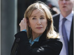 FILE - In this April 3, 2019 file photo, actress Felicity Huffman arrives at federal court in Boston to face charges in a nationwide college admissions bribery scandal. On Monday, May 13, 2019, Huffman is expected to plead guilty to charges that she took part in the cheating scam.