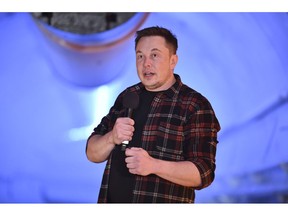 FILE - In this Tuesday, Dec. 18, 2018 file photo, Elon Musk, co-founder and chief executive officer of Tesla Inc., speaks during an unveiling event for the Boring Co. Musk will have to go to trial to defend himself for mocking a British diver as a pedophile in a verbal sparring match that unfolded last summer after the underwater rescue of youth soccer players trapped in a Thailand cave. A federal court judge in Los Angeles set an Oct. 22, 2019, trial date in a Friday, May 10, court filing that rejected Musk's attempt to dismiss a defamation lawsuit filed by British diver Vernon Unsworth.