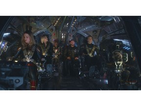 This image released by Disney shows, from left, Brie Larson, Scarlett Johansson, Don Cheadle, Chris Hemsworth, Chris Evans and the character Rocket, voiced by Bradley Cooper, in a scene from "Avengers: Endgame." (Disney/Marvel Studios via AP)