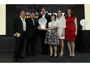 Kitkit School CEO Sooinn Lee, third from right, and Chief Engineer, Gunho Lee, second from left, receive the XPRIZE for Children's Literacy from XPRIZE Founder and Executive Chairman, Peter Diamandis, far left, Telsa CEO Elon Musk, third from left, XPRIZE CEO Anousheh Ansari, second from right, and Executive Director Emily Church, far right, Wednesday, May 15, 2019, in Los Angeles. The Berkeley-based Kitkit School and London's onebillion educational nonprofit were declared co-winners of the XPRIZE For Global Learning at a presentation Wednesday night.