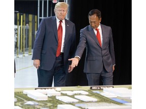 FILE - In this Thursday, June 28, 2018, file photo, President Donald Trump, left, takes a tour of Foxconn with Foxconn chairman Terry Gou in Mt. Pleasant, Wis. Gou says the Taiwanese company is moving forward with its plan to build a manufacturing facility in Wisconsin and President Donald Trump has promised to visit when production starts next year. Gou met with Trump on Wednesday to discuss the ever-changing project. Foxconn, the world's largest electronics company whose customers include Apple, Amazon and Google, plans to build a display screen factory in southeast Wisconsin.