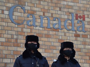 Chinese police officers stand guard outside the Canadian embassy in Beijing in December 2018.