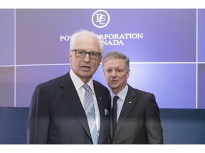Power Corporation's Chairman and Co-CEO Paul Desmarais Jr. and Deputy Chairman, President and Co-CEO Andre Desmarais pose for a photo before the start of their company's annual meeting in Toronto on Tuesday, May 14, 2019.