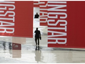 Attendees of a Morningstar investment conference walk beneath banners at the McCormick Center in Chicago.